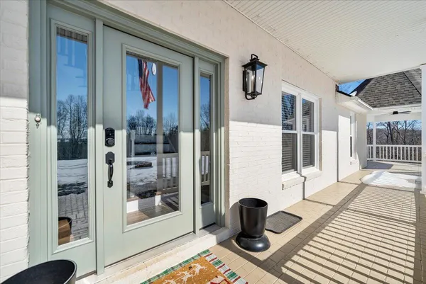 a kitchen with white cabinets and sink