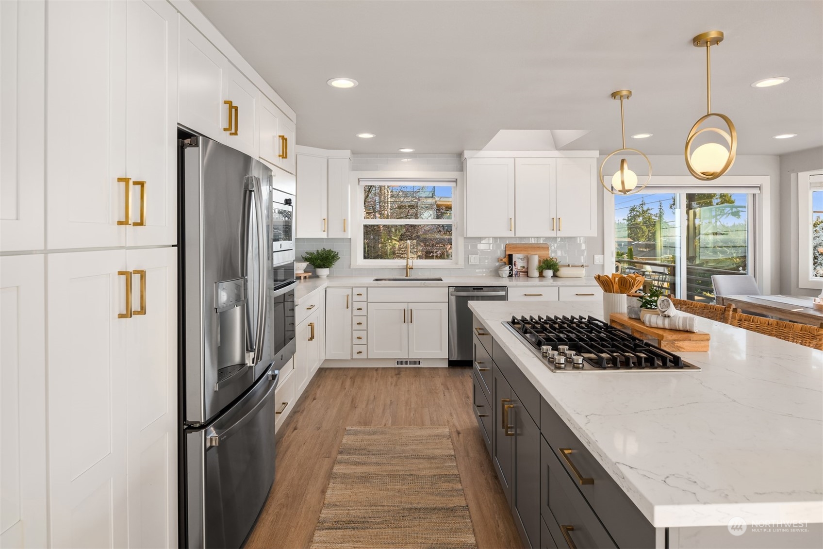 917 9th Avenue South Edmonds, WA 98020 - Photo 13 of 40 a kitchen with stainless steel appliances granite countertop a refrigerator a stove a sink dishwasher and white cabinets with wooden floor