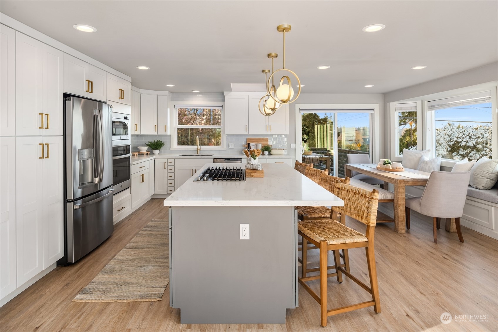 917 9th Avenue South Edmonds, WA 98020 - Photo 14 of 40 a kitchen with a dining table chairs refrigerator and stove