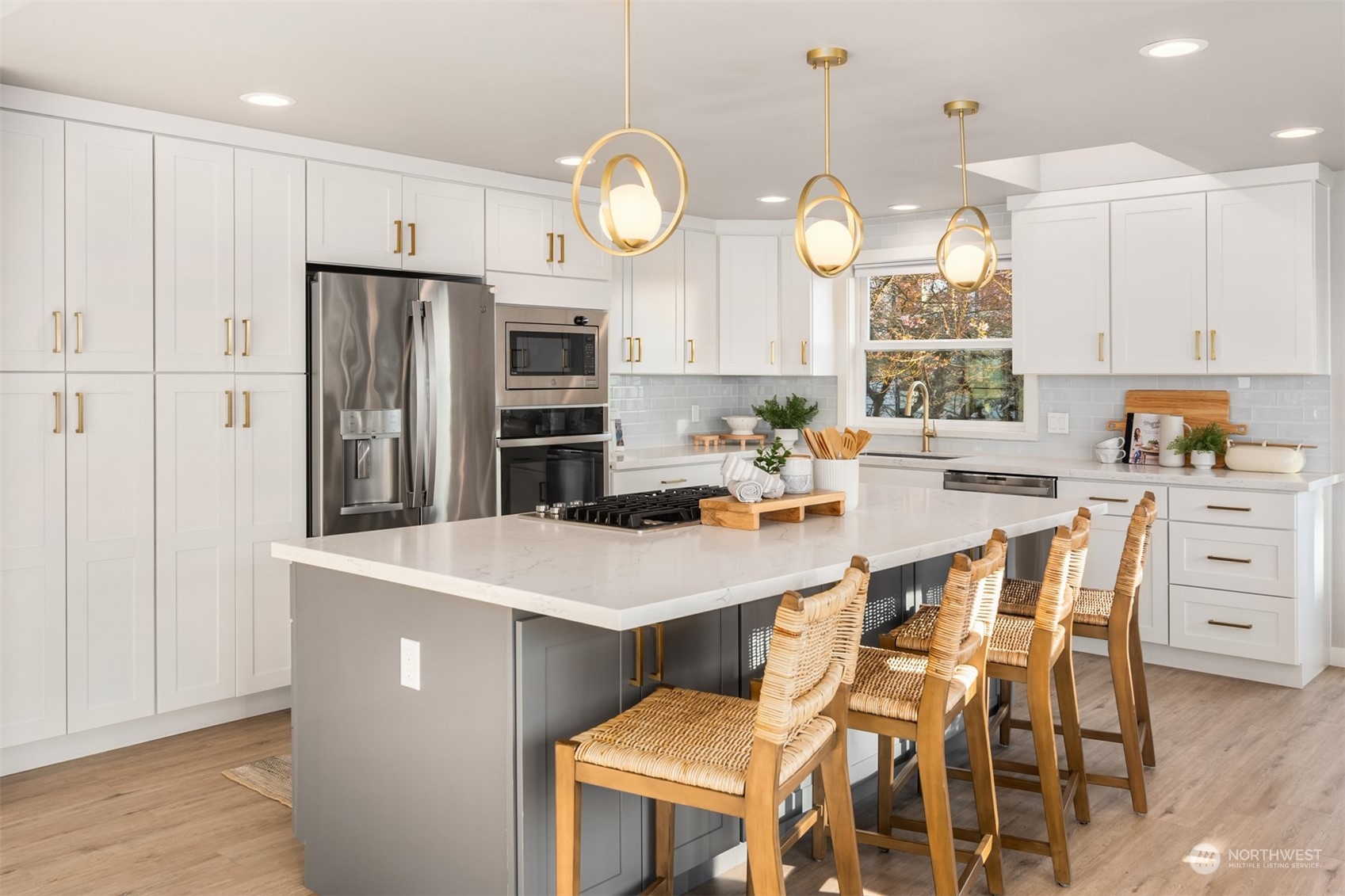 917 9th Avenue South Edmonds, WA 98020 - Photo 15 of 40 a kitchen with stainless steel appliances a table chairs and a refrigerator