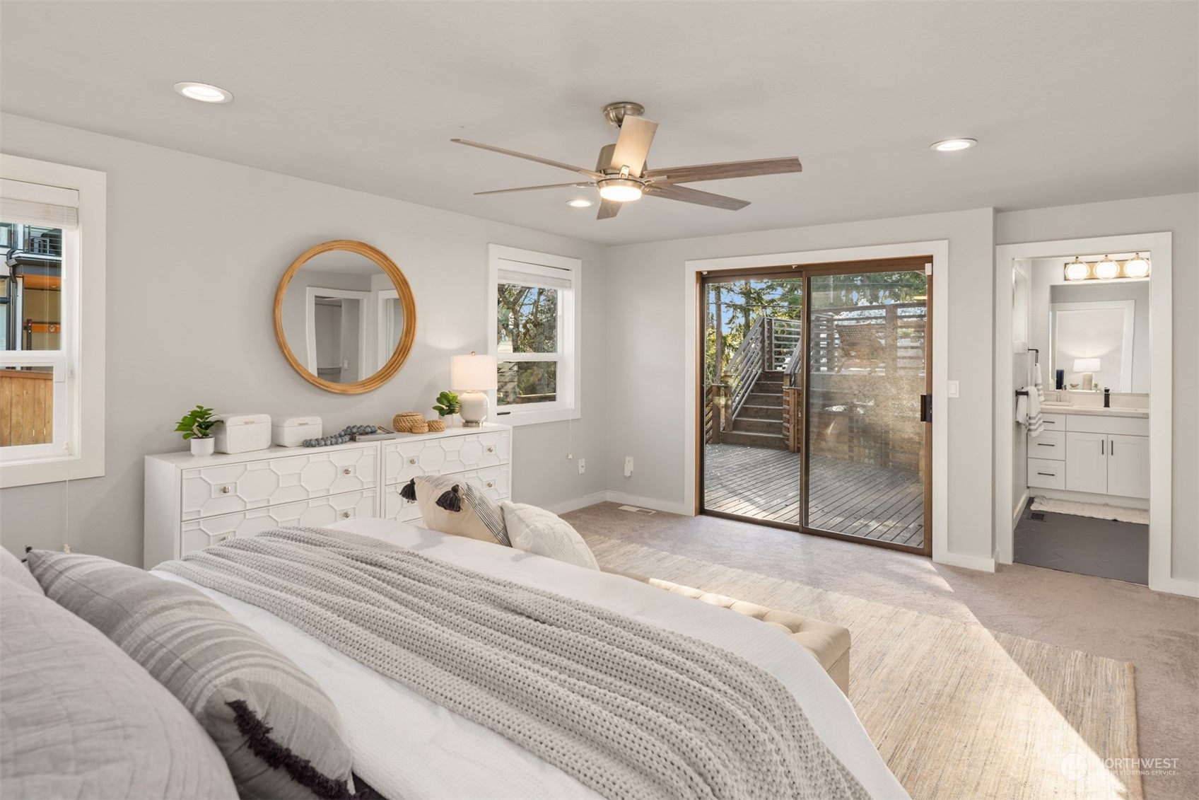 917 9th Avenue South Edmonds, WA 98020 - Photo 17 of 40 a bedroom with a large bed and a chandelier