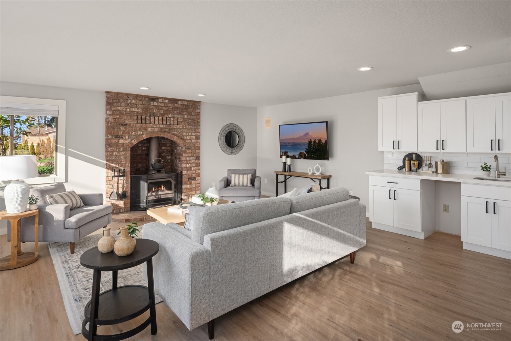 917 9th Avenue South Edmonds, WA 98020 - Photo 25 of 40 a living room with furniture a fireplace and a flat screen tv