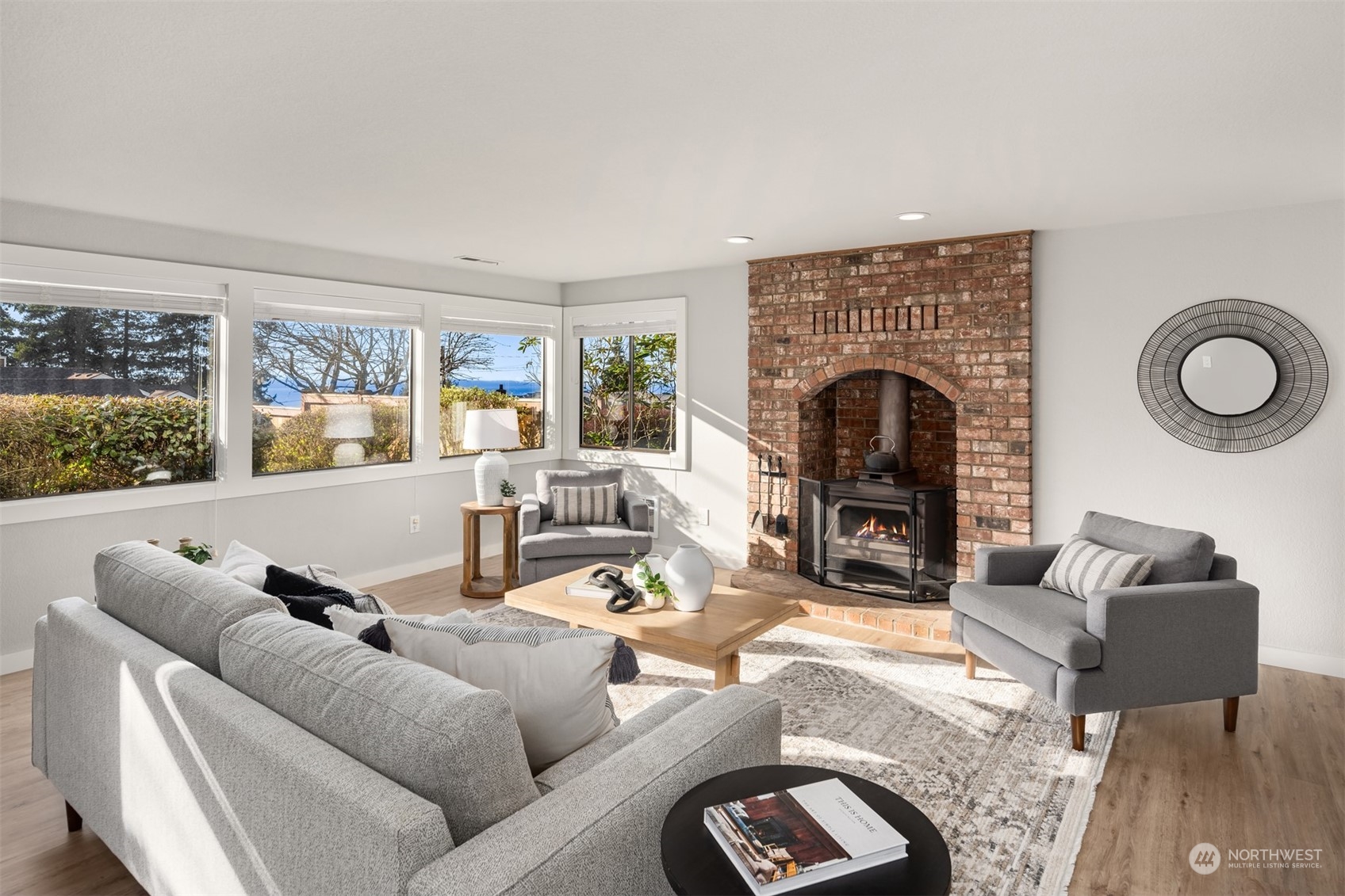 917 9th Avenue South Edmonds, WA 98020 - Photo 27 of 40 a living room with furniture a fireplace and a large window