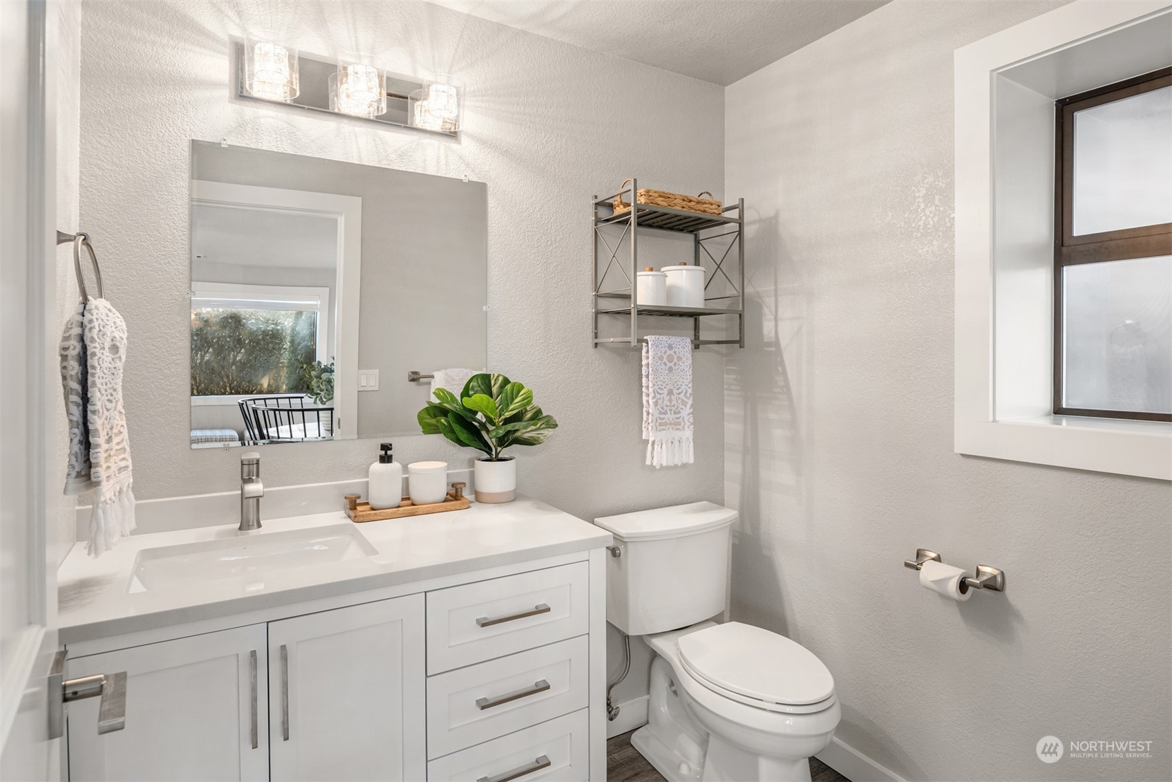 917 9th Avenue South Edmonds, WA 98020 - Photo 28 of 40 a bathroom with a sink a toilet and mirror