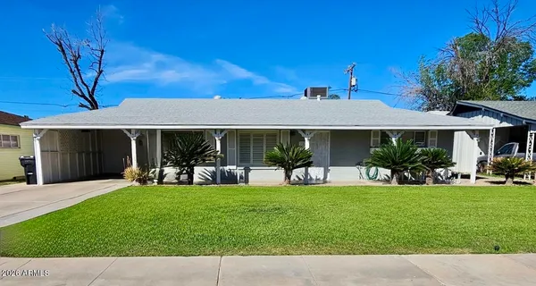 a front view of a house with a garden and patio