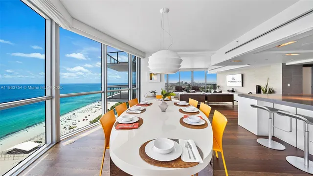 a open dining room with stainless steel appliances granite countertop a kitchen island a stove a table and chairs