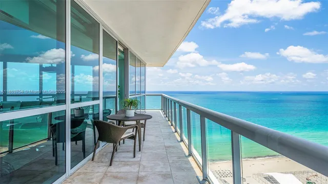 a balcony with wooden floor and outdoor seating