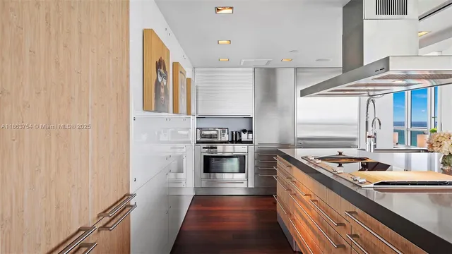 a kitchen with stainless steel appliances granite countertop a stove and a sink