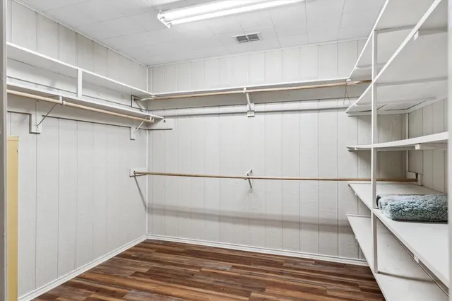 a bathroom with a granite countertop sink a mirror and a shower
