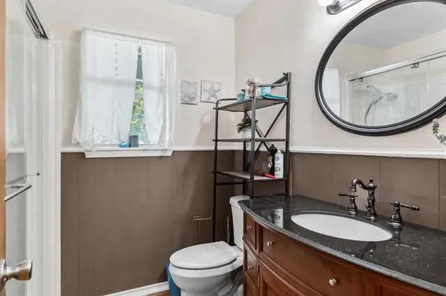 a view of a room with wooden floor and a window