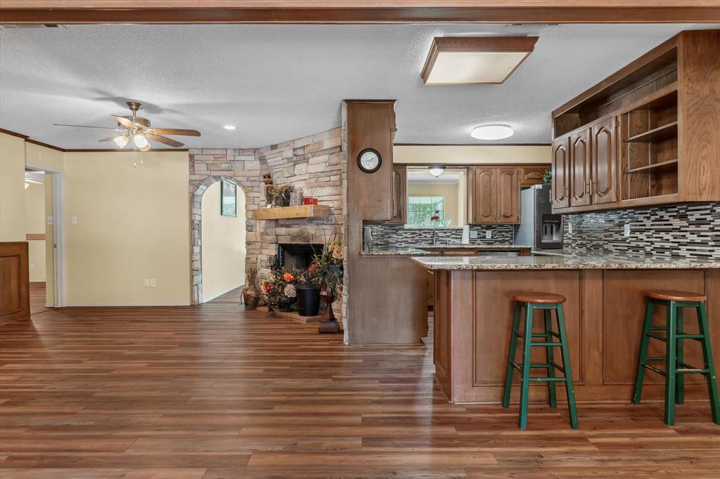 507 Cedar Street Edgewood, TX 75117 - Photo 3 of 26 a kitchen with stainless steel appliances granite countertop a refrigerator and a stove