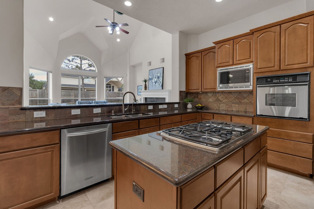 7306 Starflower Katy, TX 77494 - Photo 21 of 50 a kitchen that has a sink and a stove in it