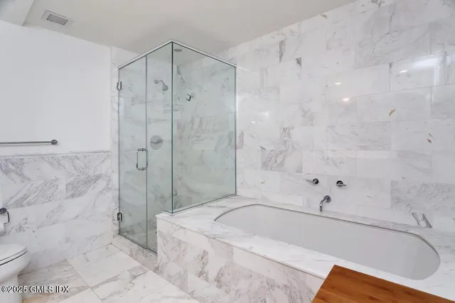 a bathroom with a bathtub and a shower