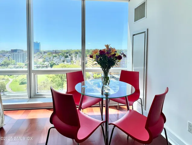 a view of a dining room with furniture window and wooden floor