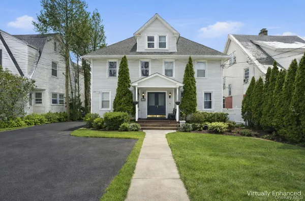 a front view of a house with a yard