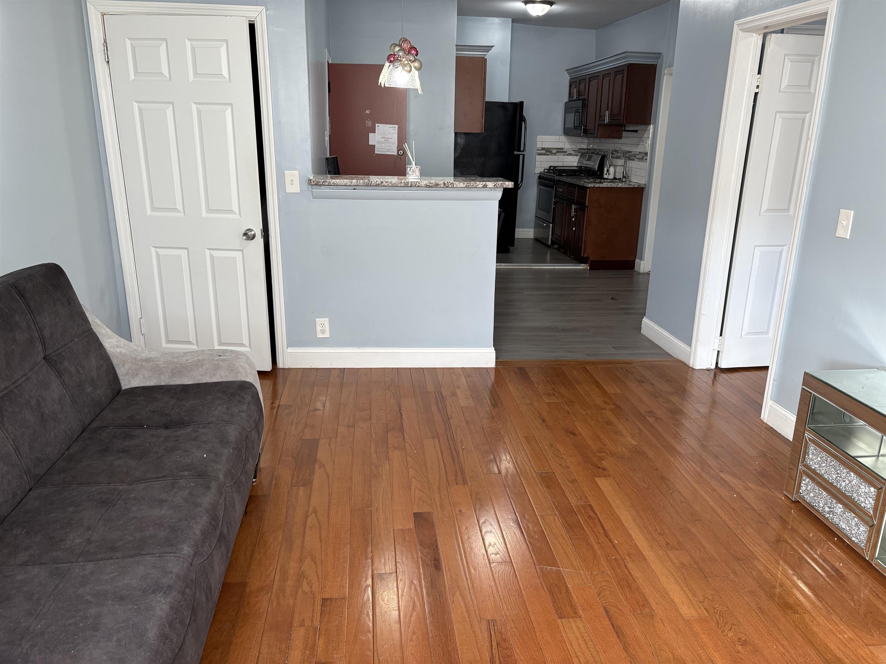 a view of a kitchen from a hallway