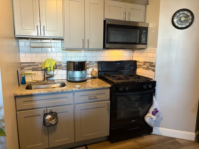a kitchen with a stove and a microwave