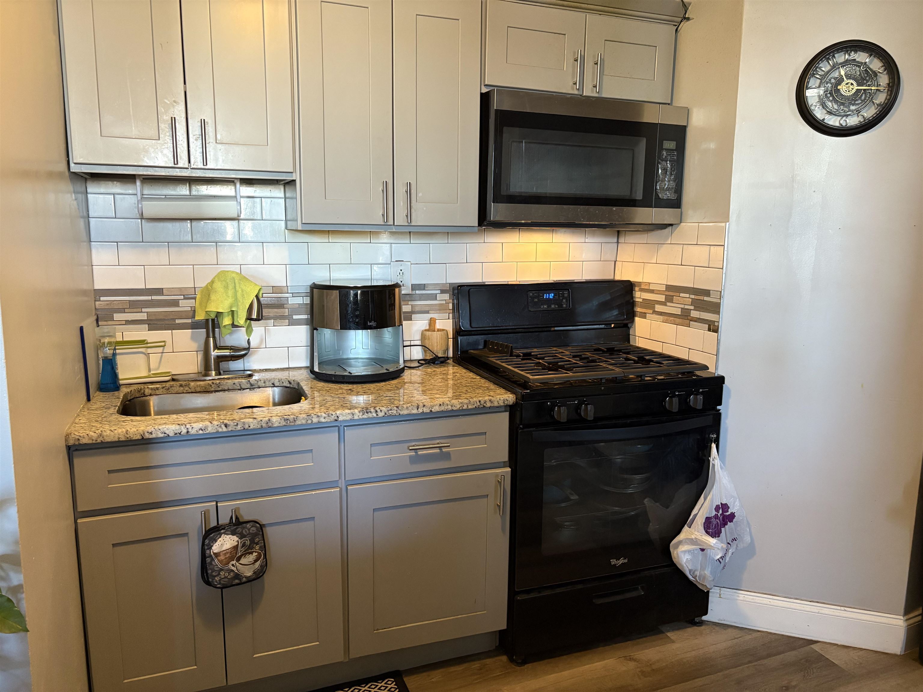 33 Emerson Avenue, Unit 5 Jersey City, NJ 07306 - Photo 3 of 8 a kitchen with a stove and a microwave