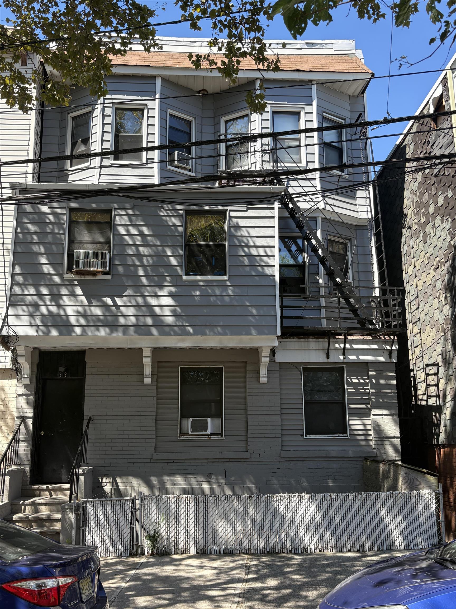 33 Emerson Avenue, Unit 5 Jersey City, NJ 07306 - Photo 8 of 8 a front view of a house with a yard