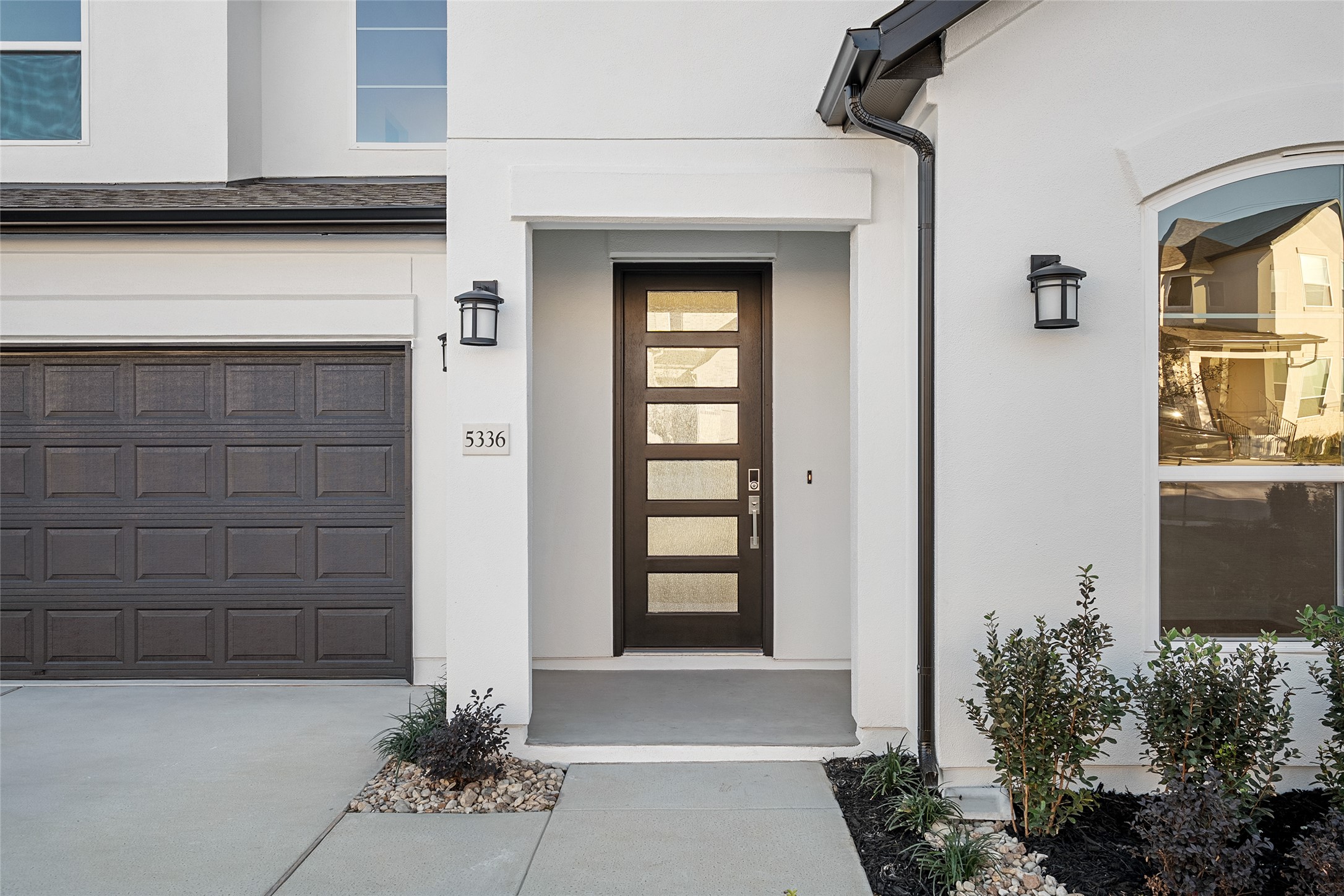 5336 Cosenza Trace Leander, TX 78641 - Photo 3 of 40 Doorway to property with stucco siding, concrete driveway, and a garage