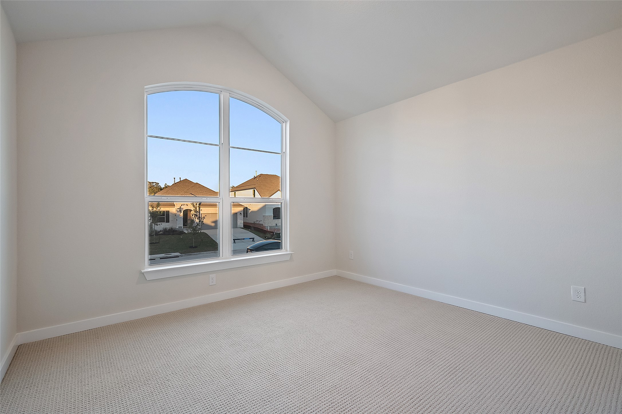 5336 Cosenza Trace Leander, TX 78641 - Photo 30 of 40 Carpeted empty room featuring baseboards and vaulted ceiling