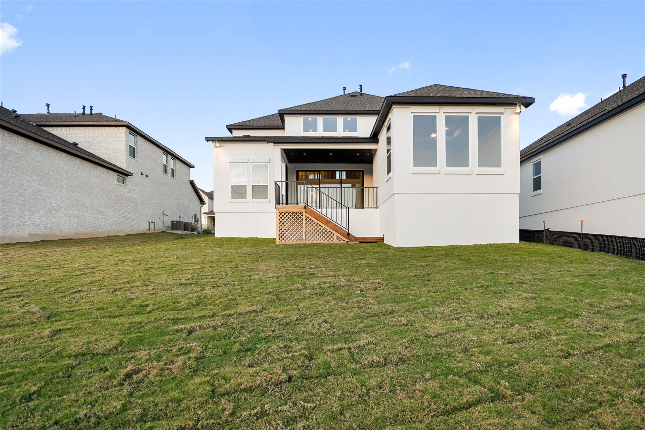 5336 Cosenza Trace Leander, TX 78641 - Photo 35 of 40 Rear view of property featuring stucco siding, a yard, and stairs