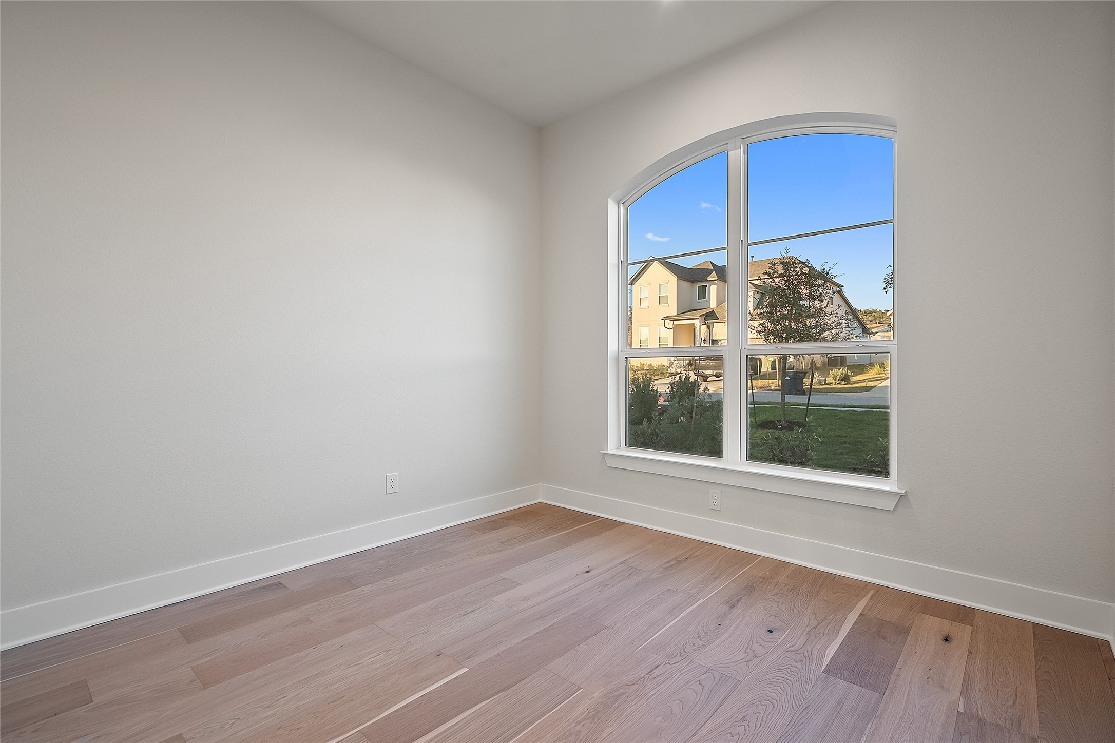 5336 Cosenza Trace Leander, TX 78641 - Photo 6 of 40 Unfurnished room featuring baseboards and light wood-style floors