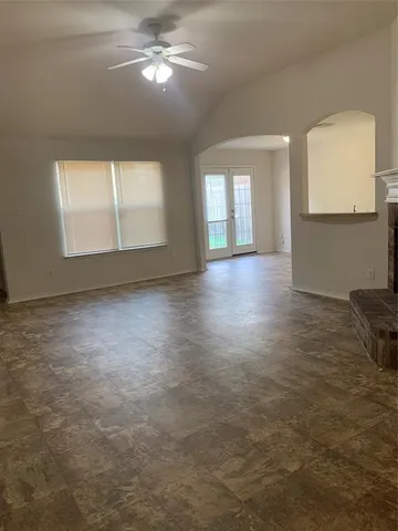 an empty room with windows and entrance