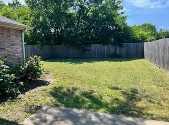 a view of patio with wooden fence
