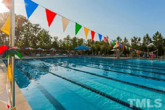 a aerial view of a house with swimming pool and glass windows