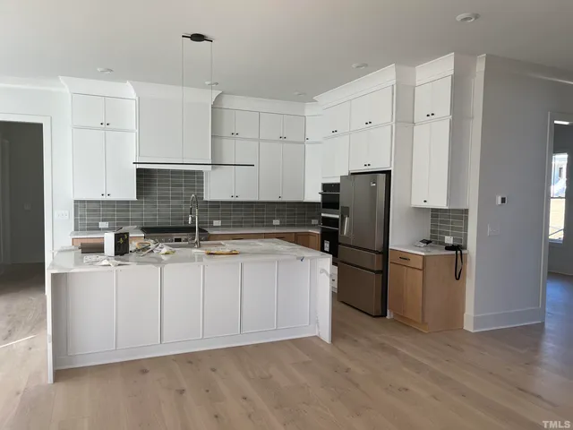 a kitchen with refrigerator and cabinets