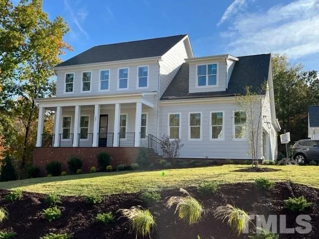 a view of a house with swimming pool and sitting area