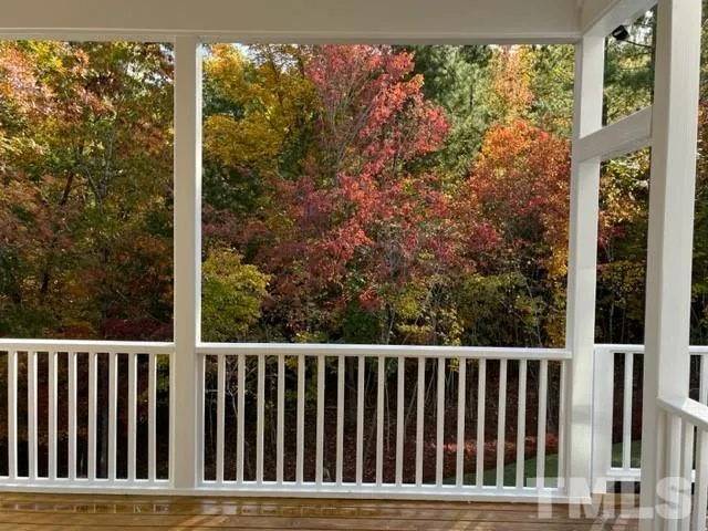 a balcony with wooden floor and fence