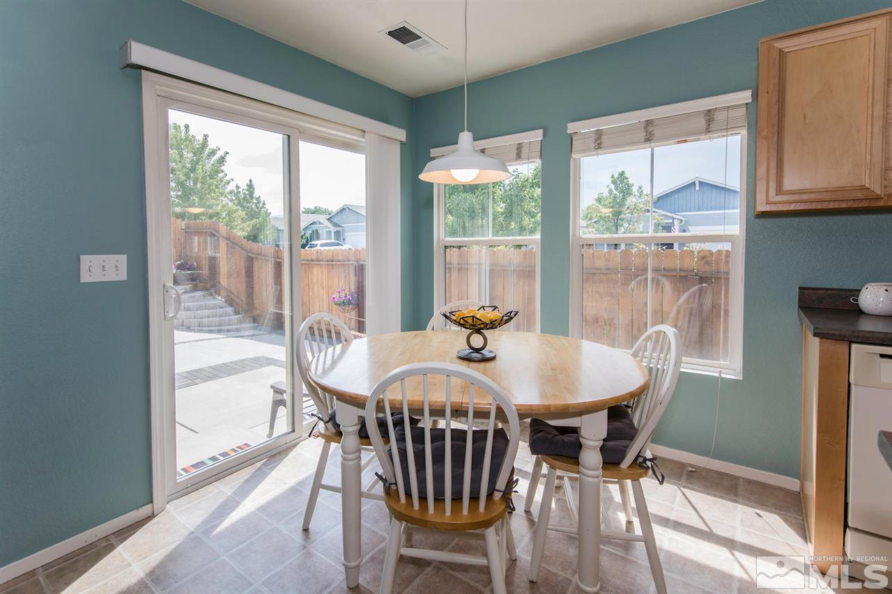 7690 Appenzell Street Reno, NV 89506 - Photo 12 of 25 a dining room with furniture a chandelier and wooden floor