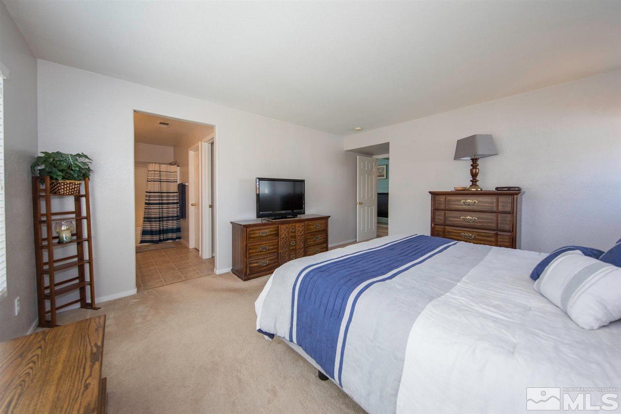 7690 Appenzell Street Reno, NV 89506 - Photo 14 of 25 a bedroom with a bed and a television