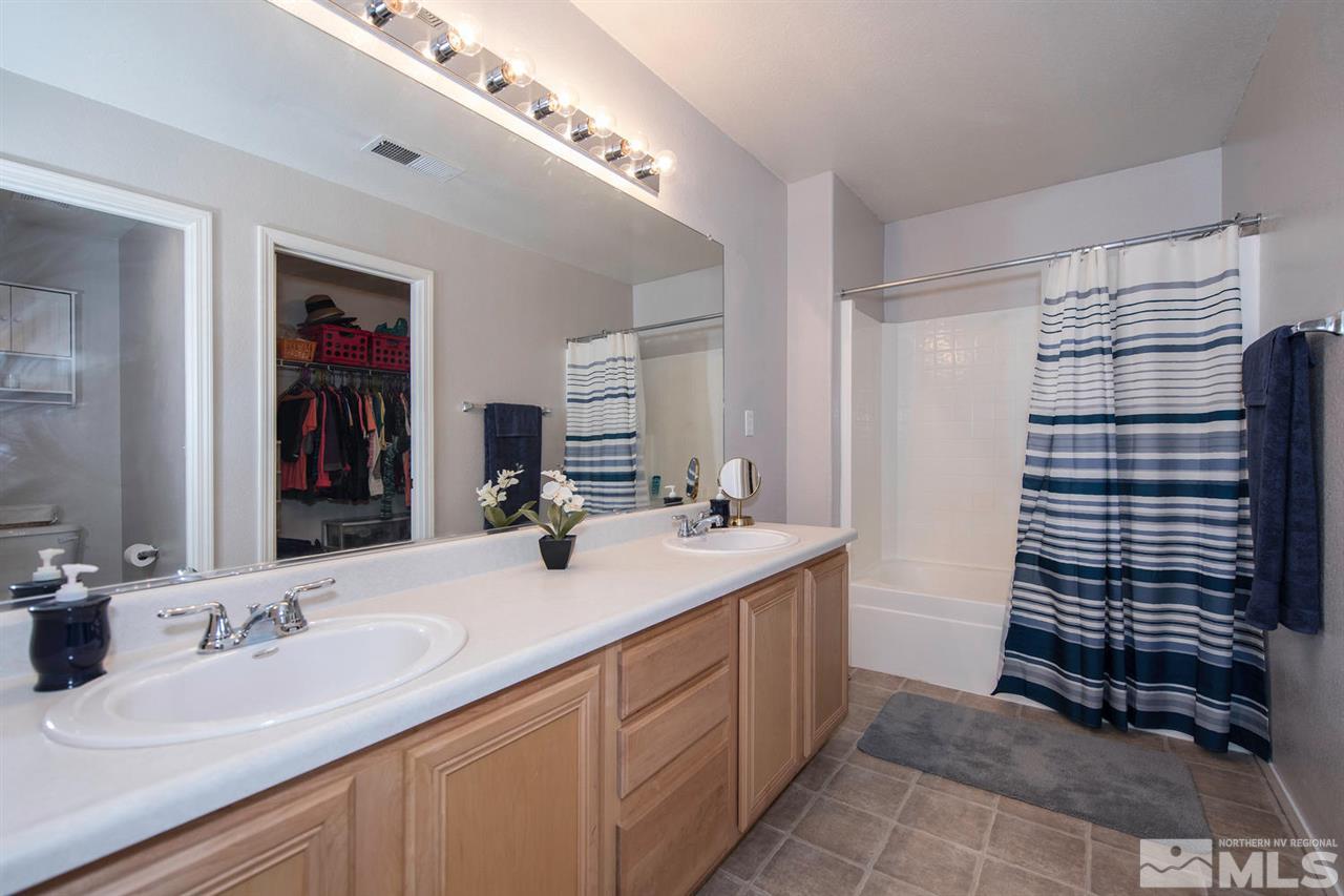 7690 Appenzell Street Reno, NV 89506 - Photo 15 of 25 a bathroom with a sink double vanity and a shower