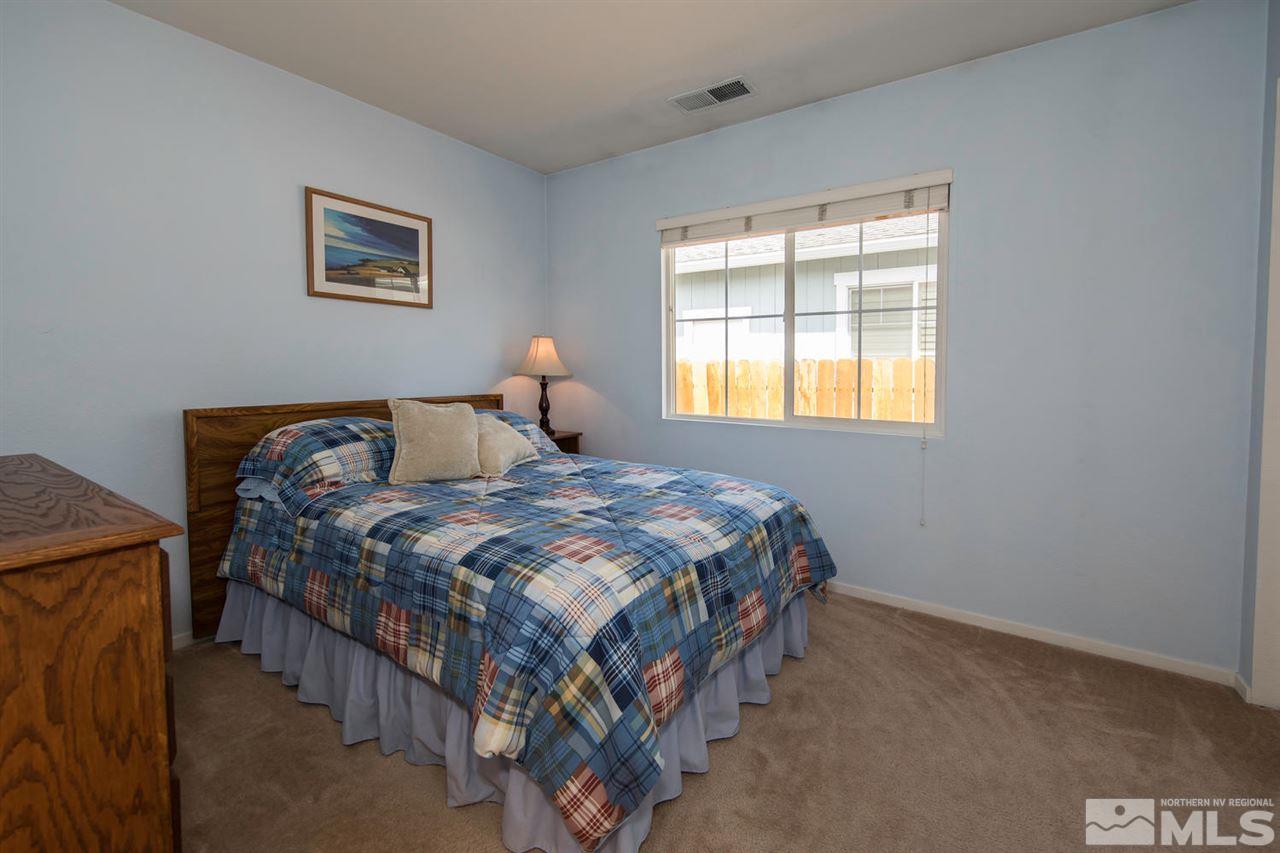 7690 Appenzell Street Reno, NV 89506 - Photo 17 of 25 a bedroom with a bed and a window