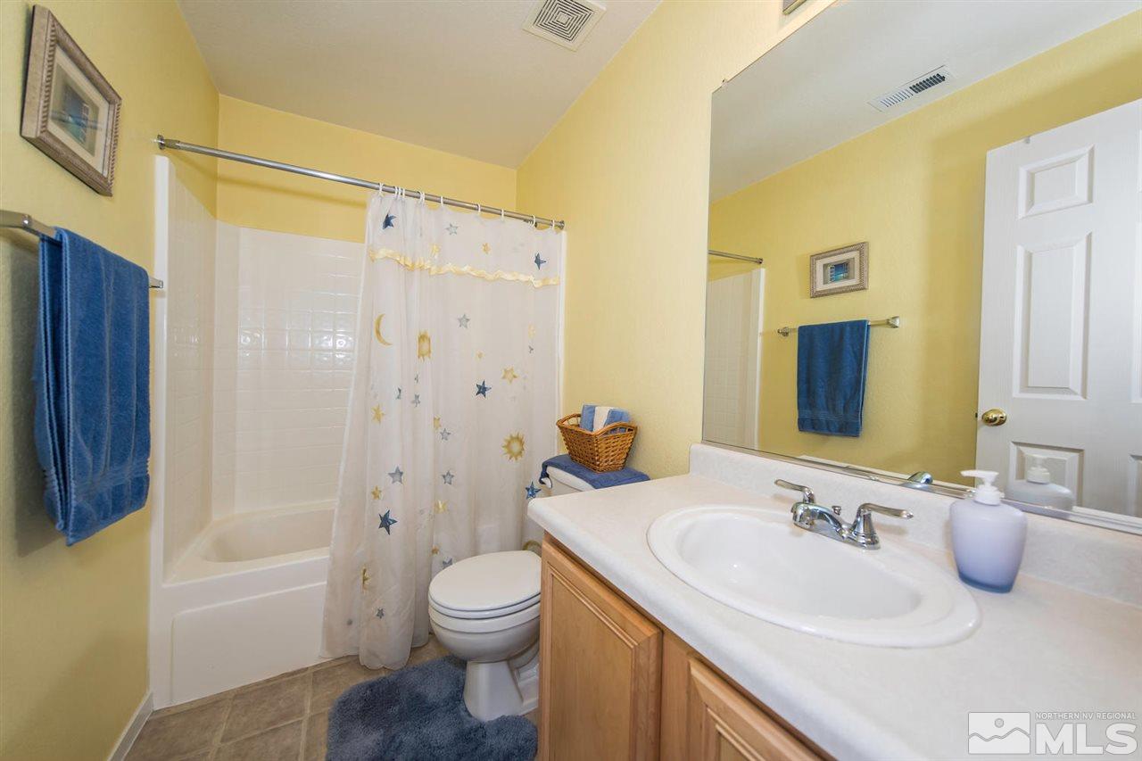7690 Appenzell Street Reno, NV 89506 - Photo 19 of 25 a bathroom with a sink a toilet and a bathtub