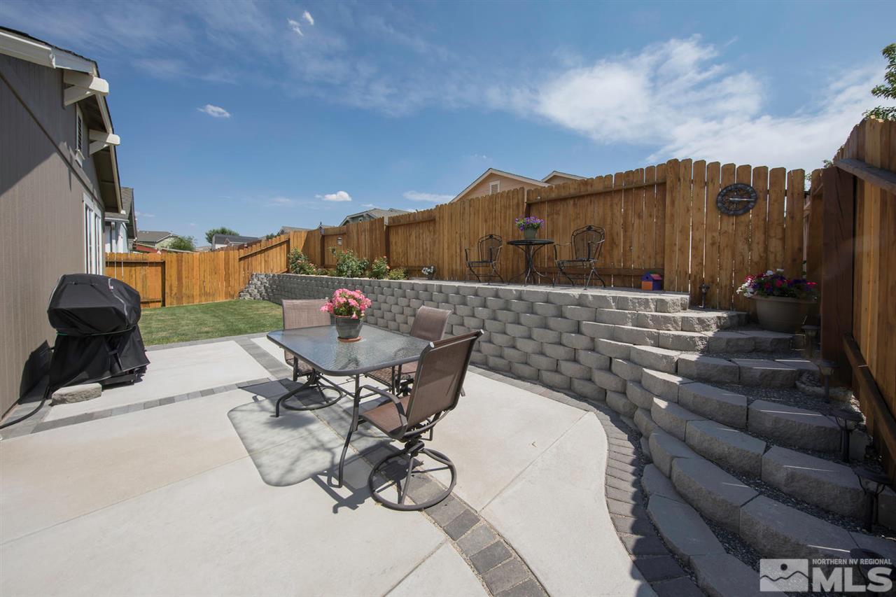 7690 Appenzell Street Reno, NV 89506 - Photo 21 of 25 a view of a patio with table and chairs and potted plants