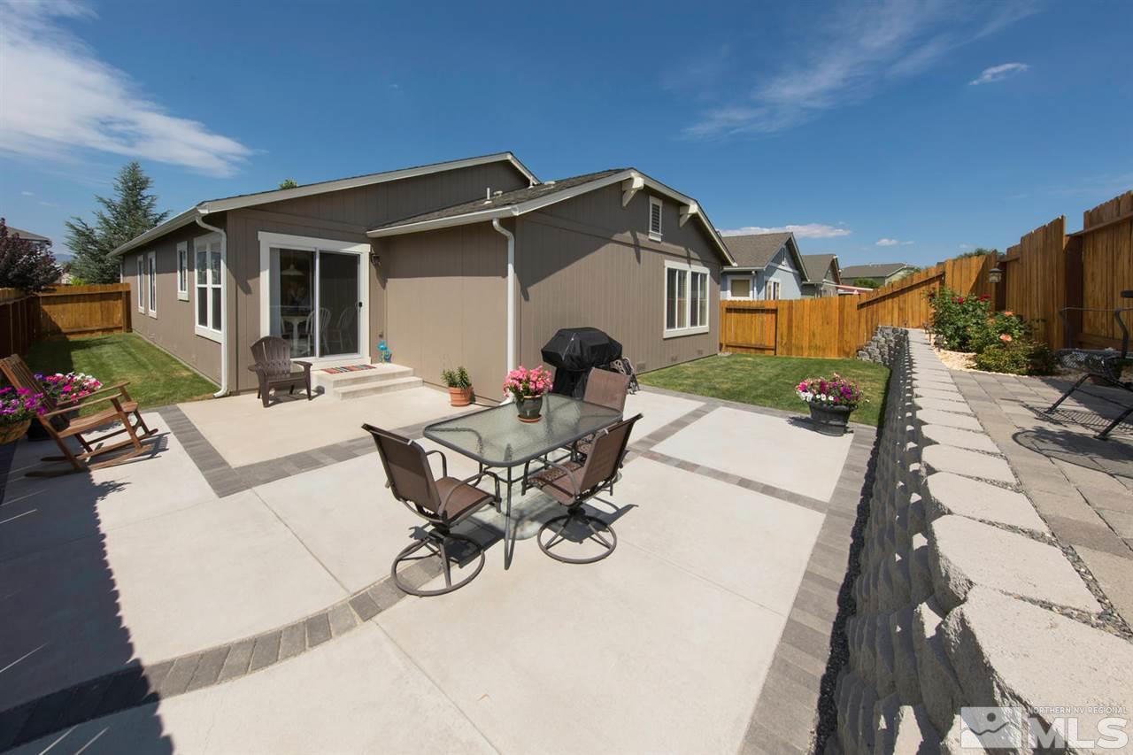 7690 Appenzell Street Reno, NV 89506 - Photo 22 of 25 a view of a patio with table and chairs with wooden floor and fence