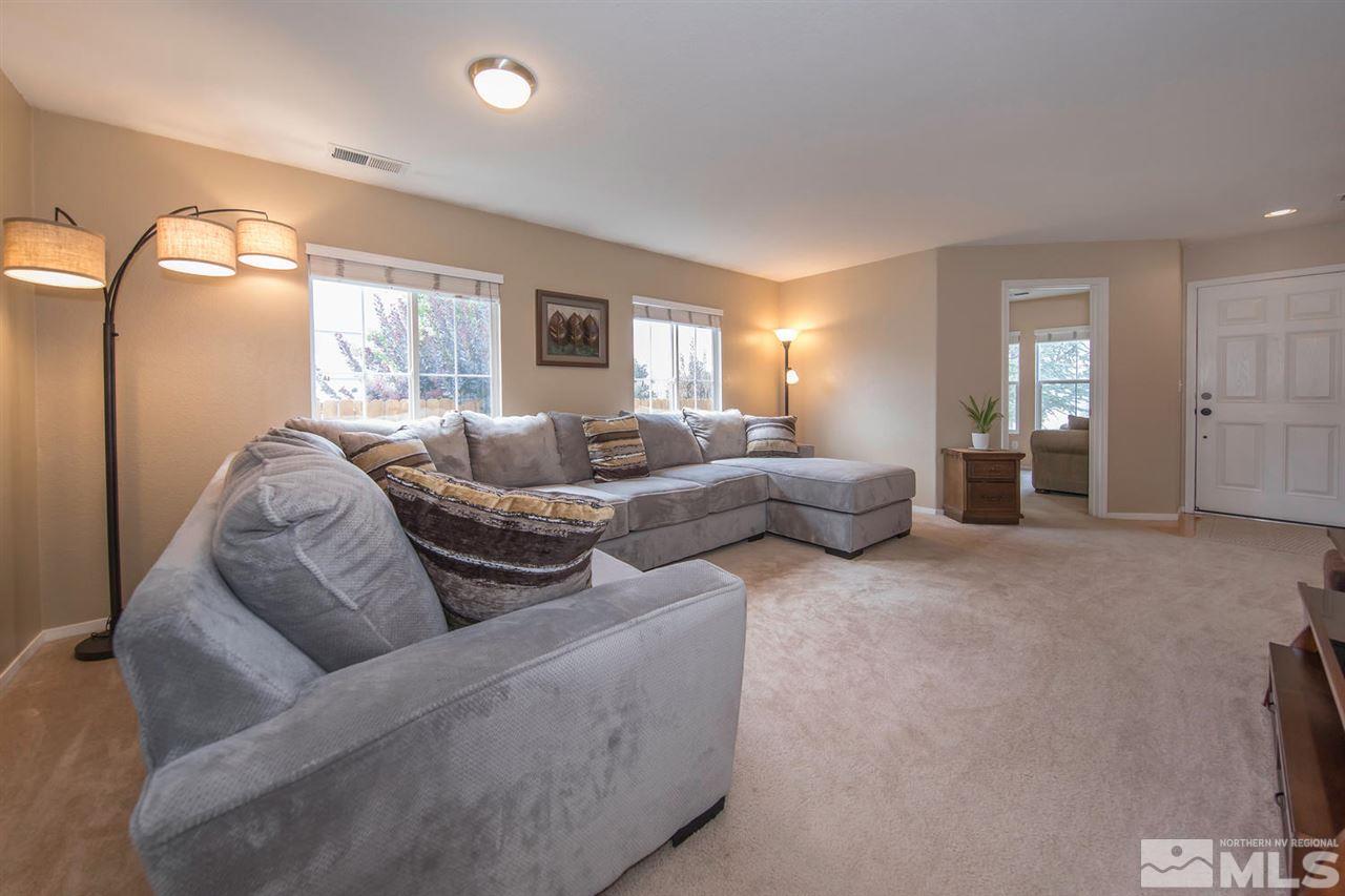 7690 Appenzell Street Reno, NV 89506 - Photo 3 of 25 a living room with furniture and a large window