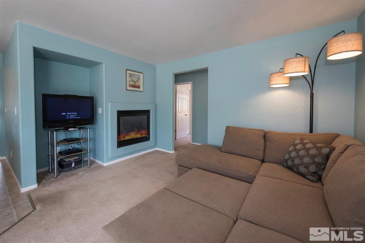7690 Appenzell Street Reno, NV 89506 - Photo 8 of 25 a living room with furniture and a flat screen tv