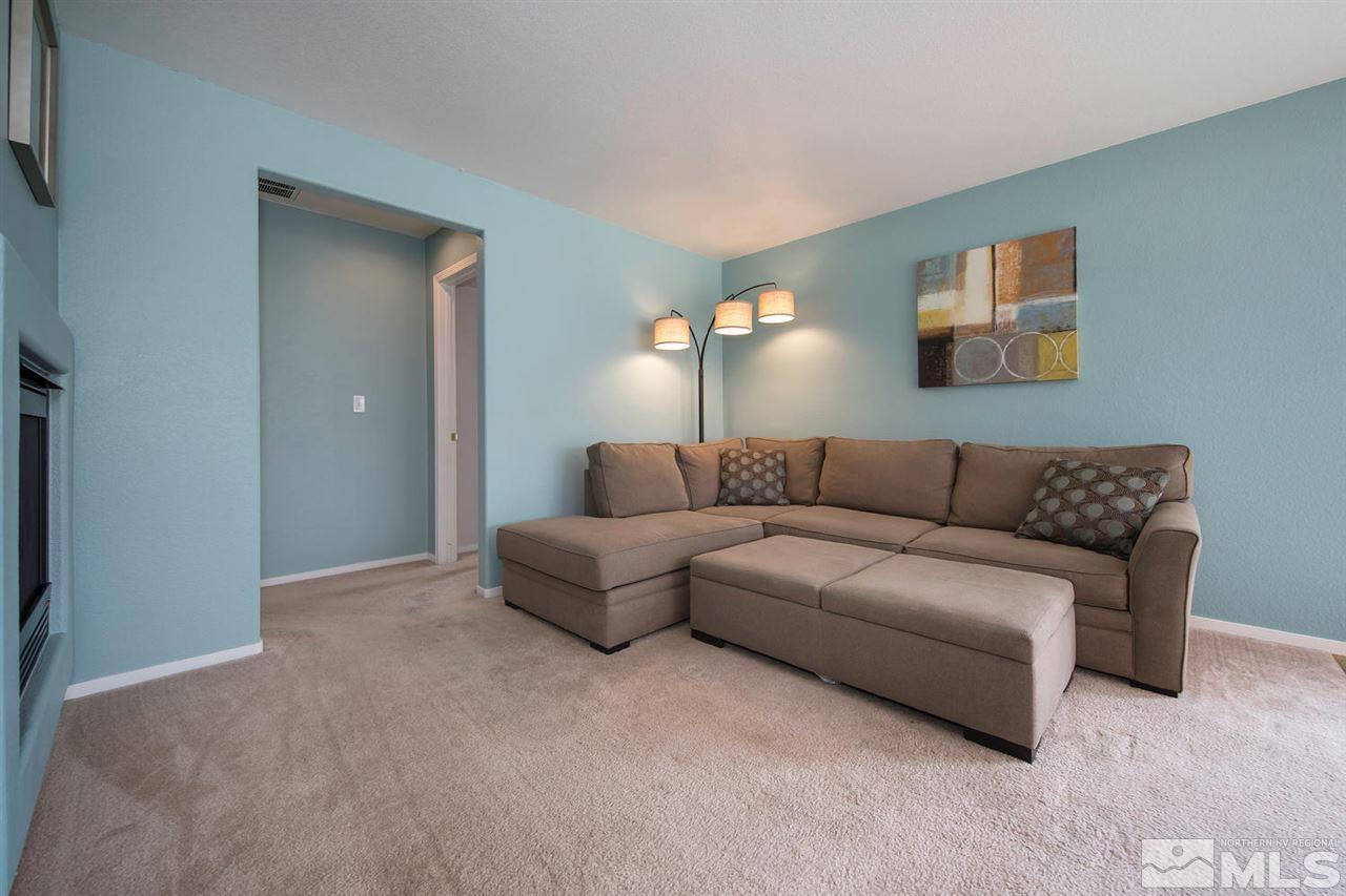 7690 Appenzell Street Reno, NV 89506 - Photo 9 of 25 a living room with furniture and a lamp