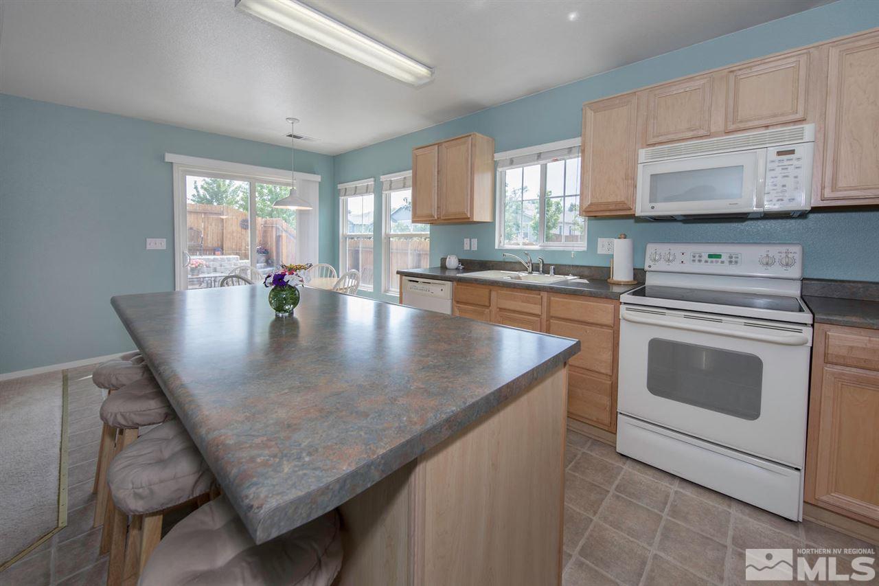 7690 Appenzell Street Reno, NV 89506 - Photo 10 of 25 a kitchen with a stove a sink and cabinets