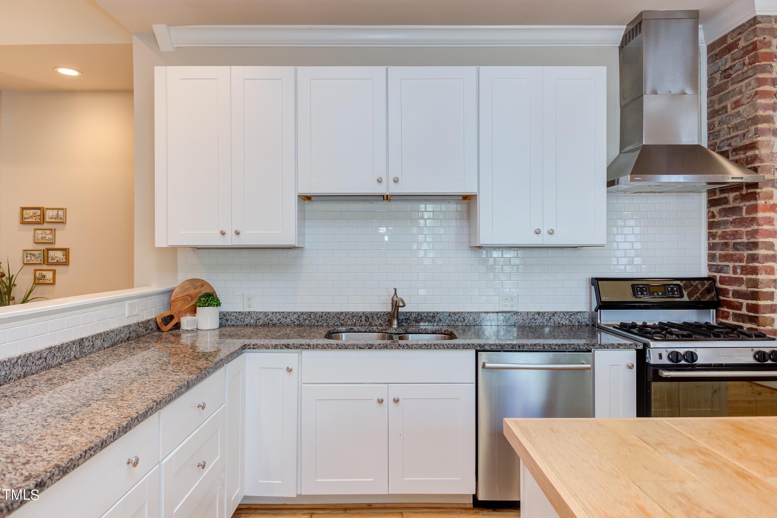 2222 Creston Road Raleigh, NC 27608 - Photo 14 of 57 a kitchen with granite countertop white cabinets and stainless steel appliances