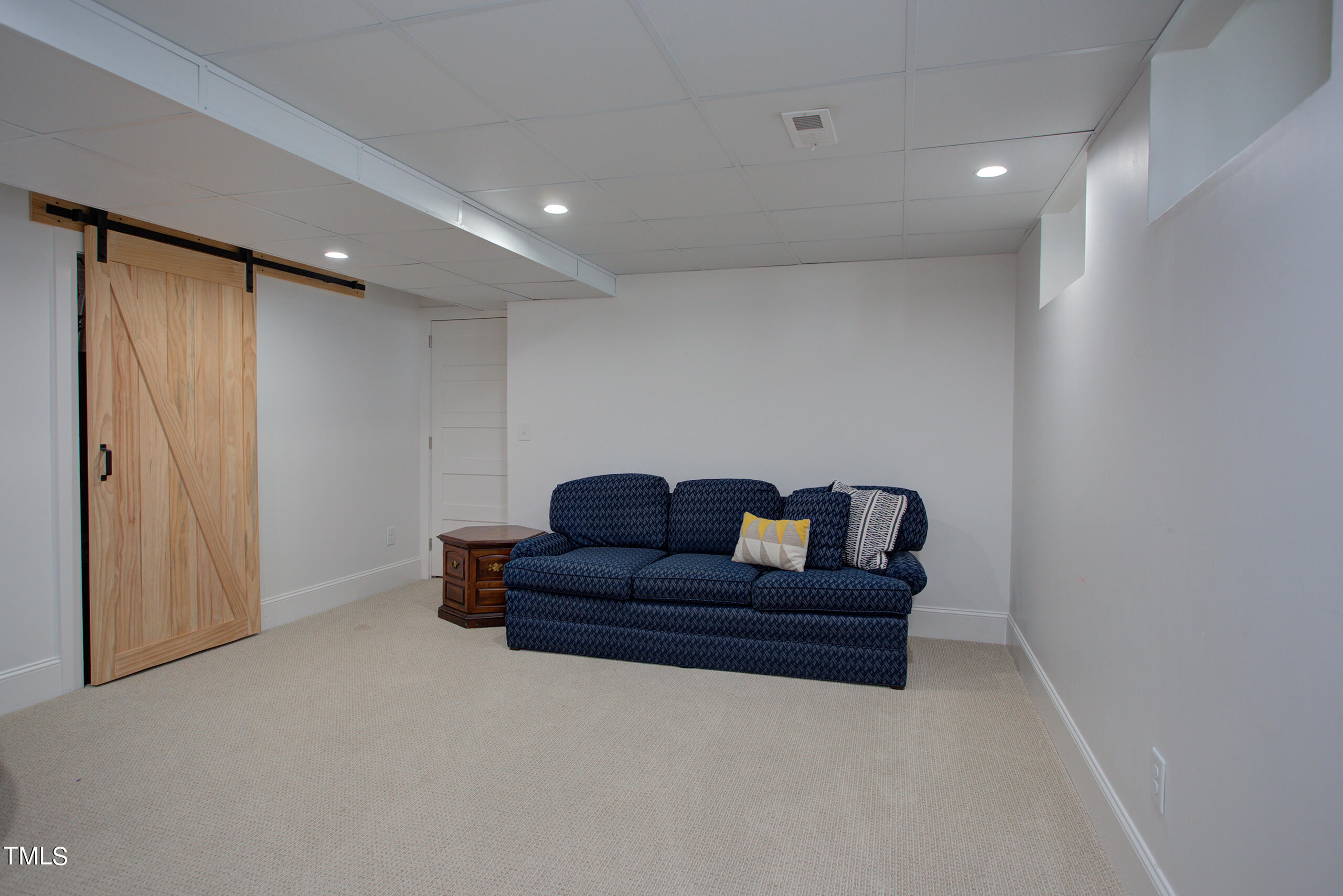 2222 Creston Road Raleigh, NC 27608 - Photo 41 of 57 a living room with couch and a wall painting