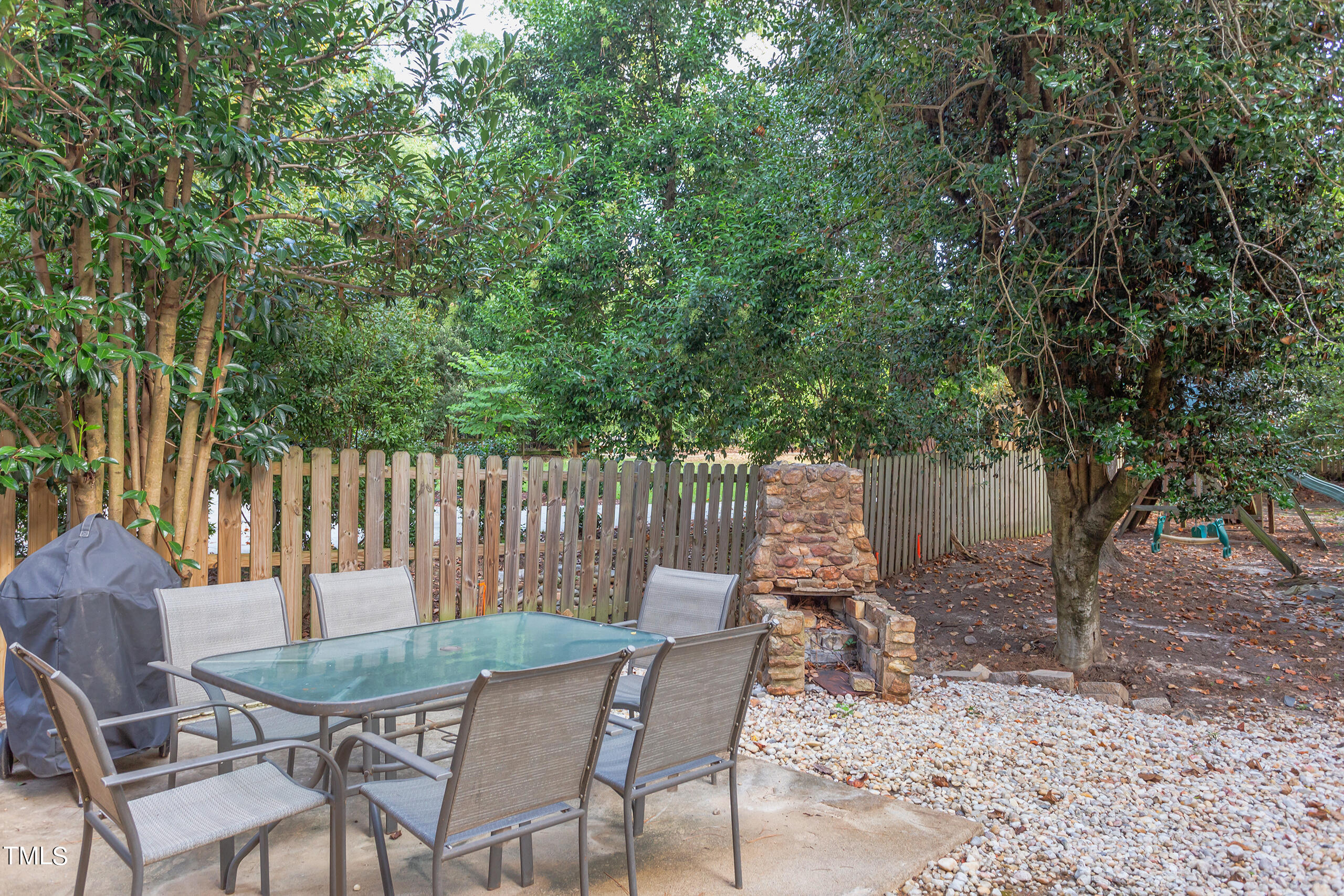 2222 Creston Road Raleigh, NC 27608 - Photo 46 of 57 a backyard of a house with table and chairs