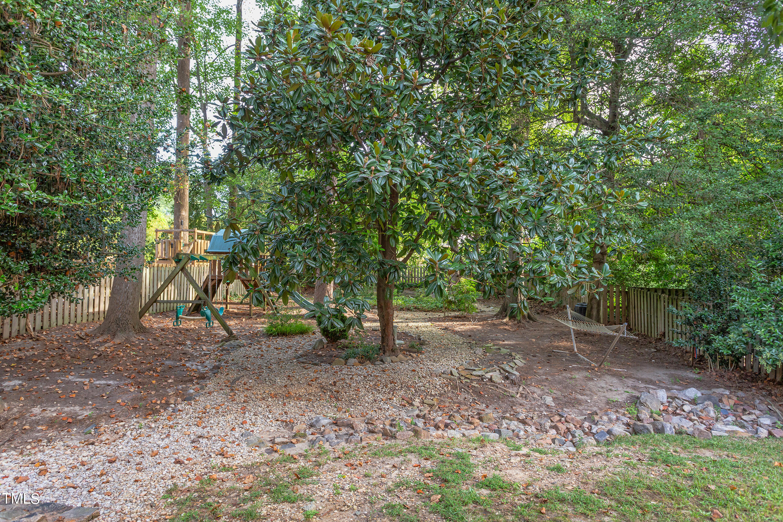 2222 Creston Road Raleigh, NC 27608 - Photo 48 of 57 a view of a yard with a tree