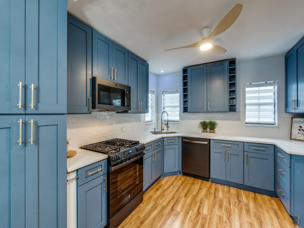 5739 Ellsworth Avenue Dallas, TX 75206 - Photo 14 of 38 a kitchen with stainless steel appliances granite countertop wooden cabinets a stove top oven a sink and dishwasher