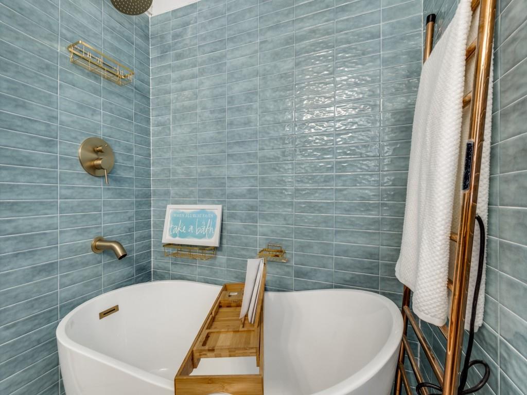 5739 Ellsworth Avenue Dallas, TX 75206 - Photo 24 of 38 a bathroom with a tub and a shower
